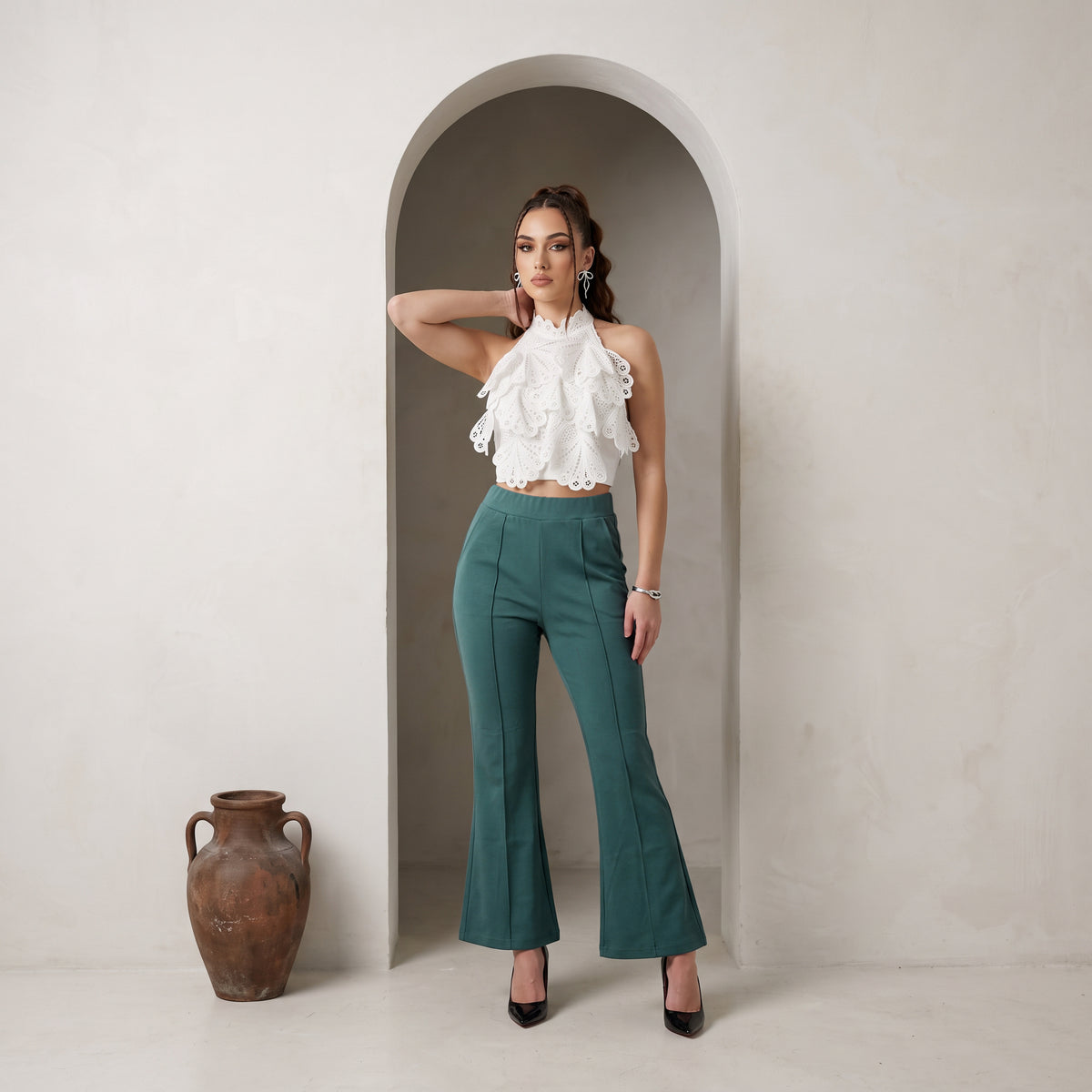 Bottle Green Bell bottom. Made from Imported Lycra Fabric, it has pintex design on the front and has no pockets and zipper