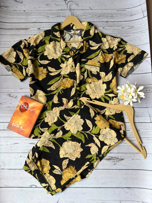 Floral shirt on a hanger with a box on a wooden surface