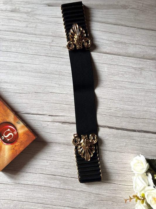 Elasticated black belt with bold and designer buckle in golden colour.