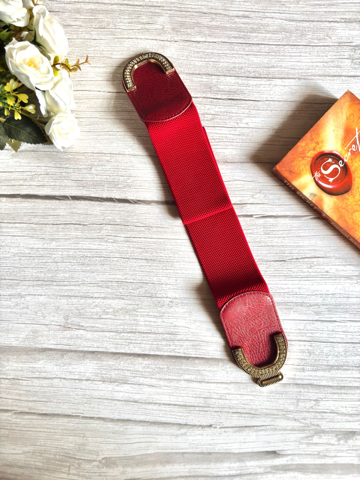 Elascticated Waist belt in cherry maroon colour with gold buckle