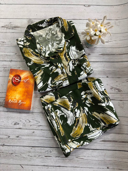Floral-patterned fabric on a wooden surface with a book titled 'Sweet' by Rachel Caine.