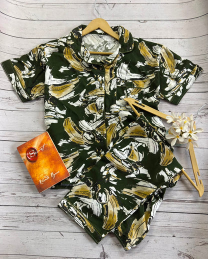 Floral patterned shirt on a wooden surface with a card and flower decoration.