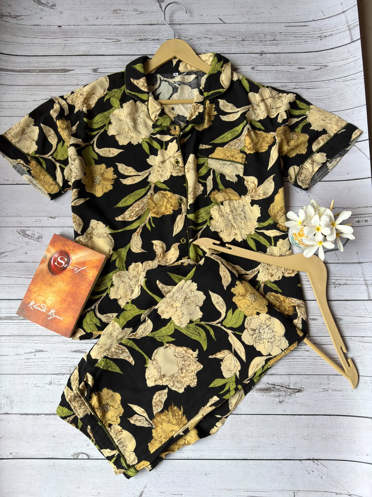 Floral shirt on a hanger with a box on a wooden surface