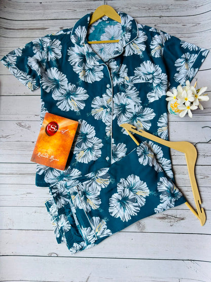 Floral patterned shirt on a wooden hanger with a wooden background